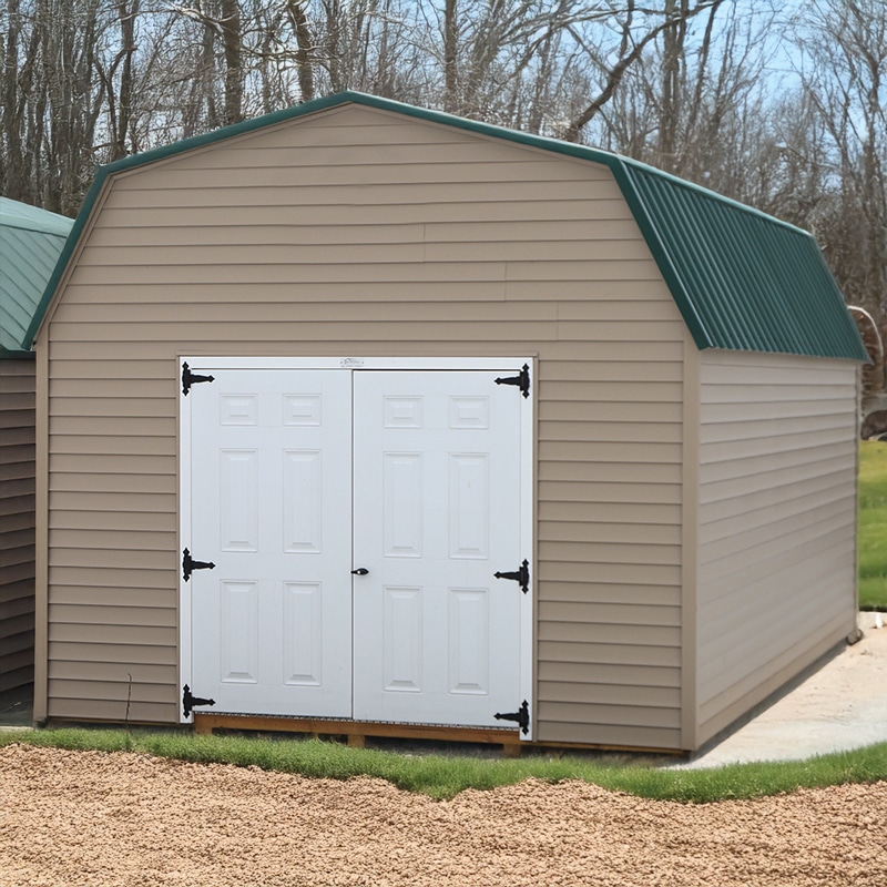 Lofted barn with taupe vinyl siding and green metal roof