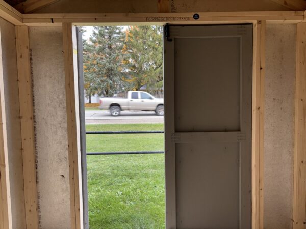 Interior looking out the double door entrance of a gable utility shed