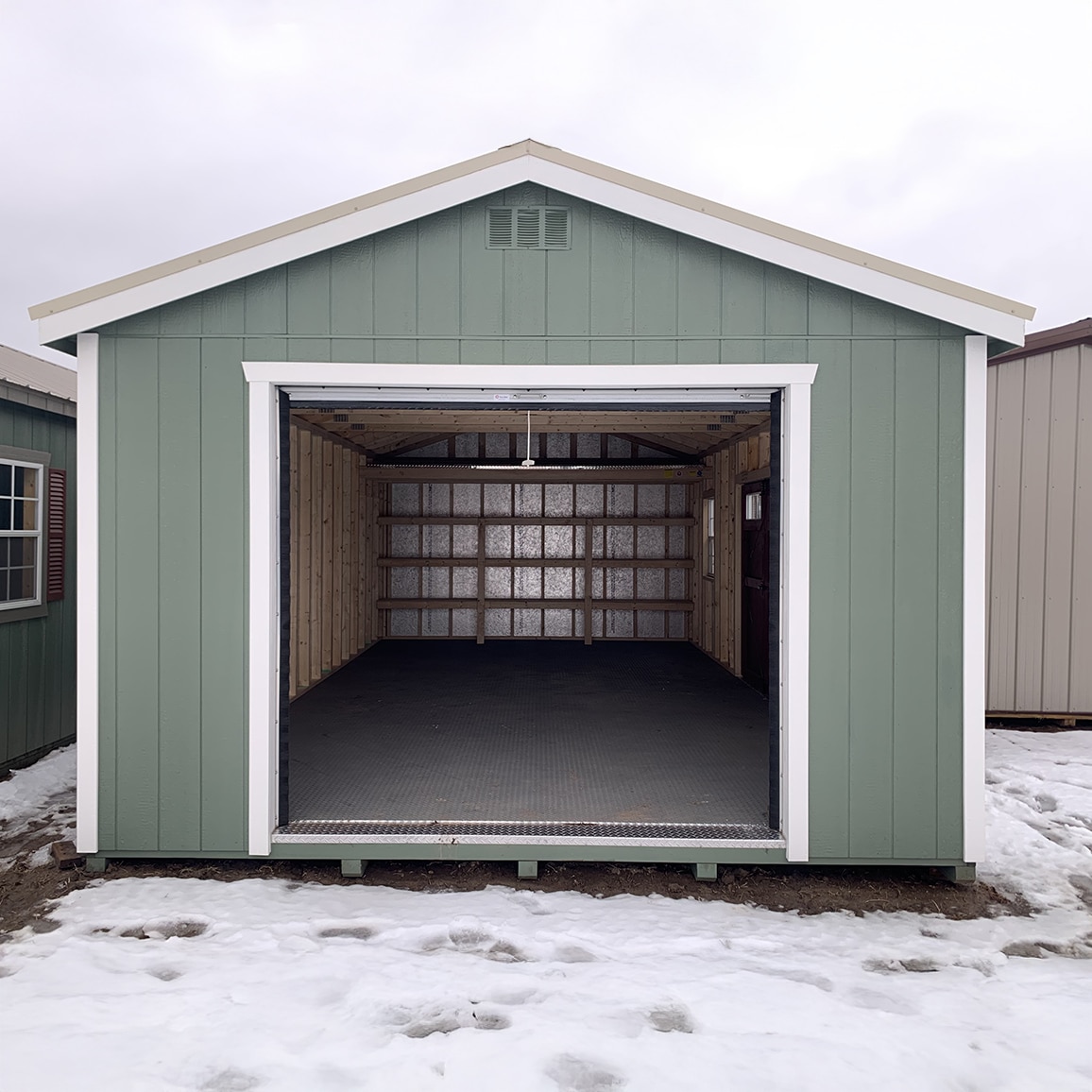 Green gable garage in the snow